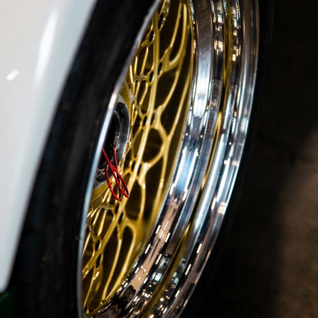 A close up of a wheel on a white car